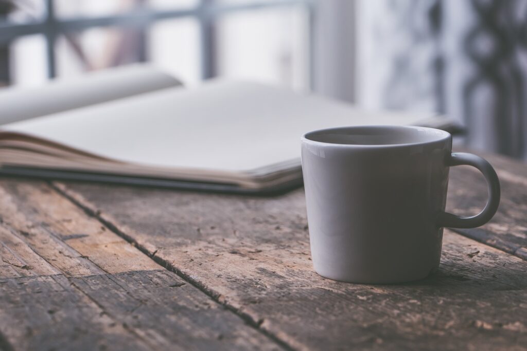 Coffe and notebook ona table implying working from home