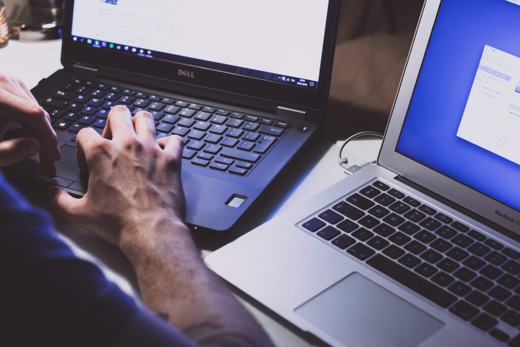 Person with two laptops - symbolising a client who could do with some buying advice